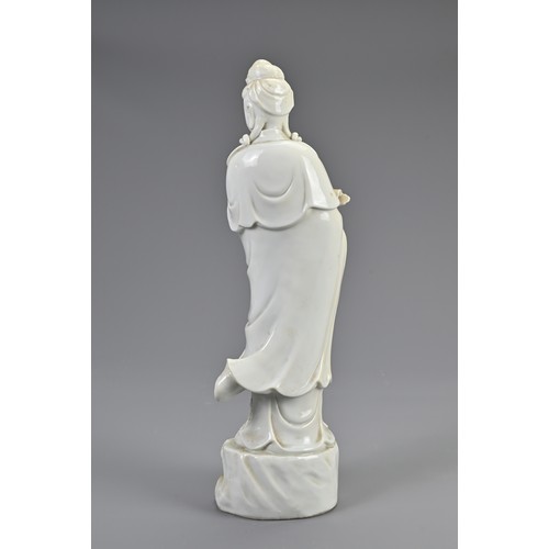 140 - A CHINESE BLANC DE CHINE PORCELAIN FIGURE OF GUANYIN, 20TH CENTURY. Standing figure dressed in robes... 