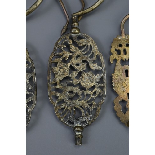 86 - A GROUP OF SIX CHINESE METALWARE BIRDCAGE HOOKS, EARLY 20TH CENTURY. With pierced sections depicting... 