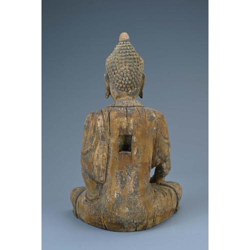 181 - A CARVED WOODEN FIGURE OF SEATED BUDDHA, MING DYNASTY OR LATER. The figure dressed in robes with ser... 