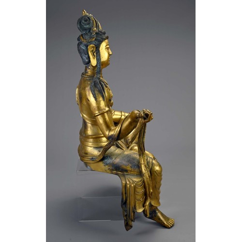 189 - A LARGE TIBETAN GILT BRONZE FIGURE OF GUANYIN. The Bodhisattva seated in royal ease pose holding sec... 