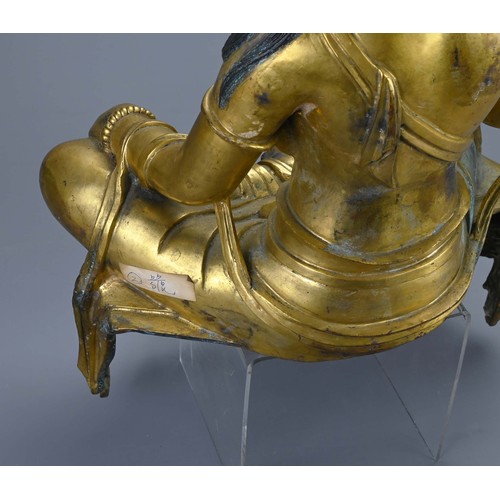 189 - A LARGE TIBETAN GILT BRONZE FIGURE OF GUANYIN. The Bodhisattva seated in royal ease pose holding sec... 