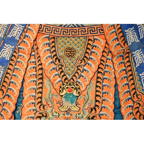 191 - A CHINESE EMBROIDERED OPERA ROBE, 20TH CENTURY. Orange ground decorated with blue silk embroidered d... 