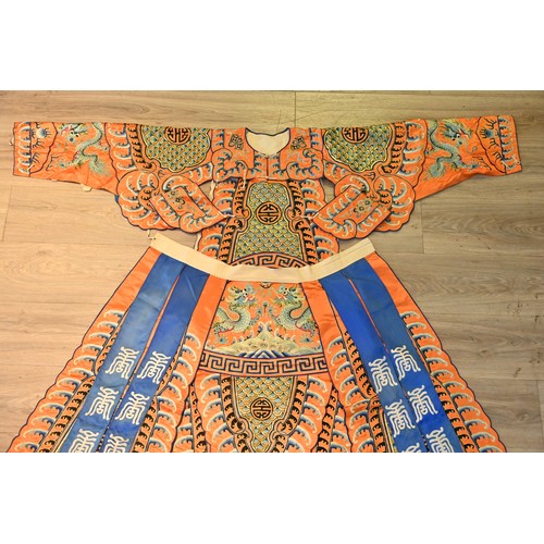 191 - A CHINESE EMBROIDERED OPERA ROBE, 20TH CENTURY. Orange ground decorated with blue silk embroidered d... 