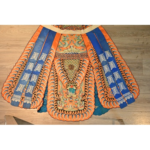 191 - A CHINESE EMBROIDERED OPERA ROBE, 20TH CENTURY. Orange ground decorated with blue silk embroidered d... 