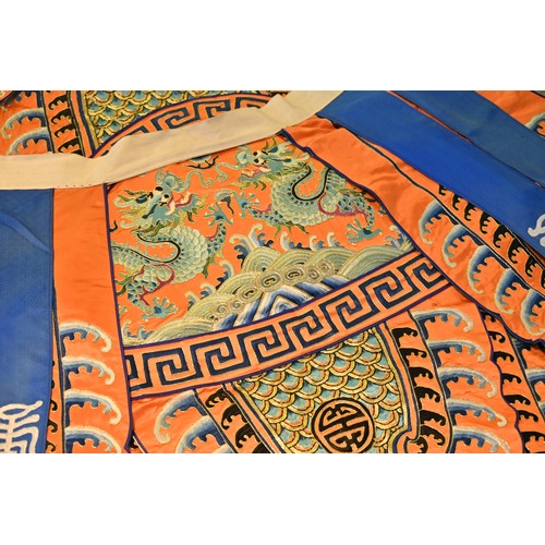 191 - A CHINESE EMBROIDERED OPERA ROBE, 20TH CENTURY. Orange ground decorated with blue silk embroidered d... 