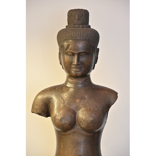 182 - A VERY LARGE AND HEAVY CARVED GREY STONE FIGURE OF FEMALE DEITY, KHMER BAPHUON STYLE. Fitted onto a ... 