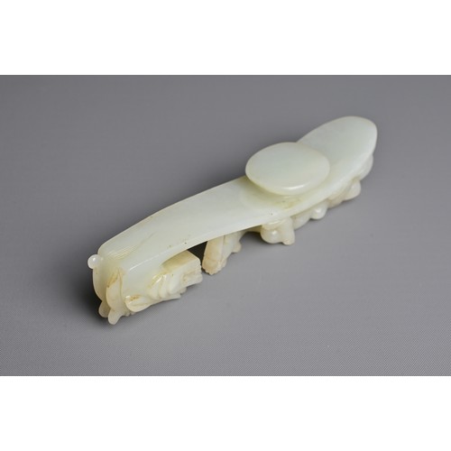 108 - A LARGE CHINESE PALE CELADON JADE BELT HOOK, 18/19TH CENTURY. Carved and pierced section featuring a... 