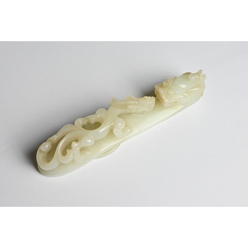 108 - A LARGE CHINESE PALE CELADON JADE BELT HOOK, 18/19TH CENTURY. Carved and pierced section featuring a... 