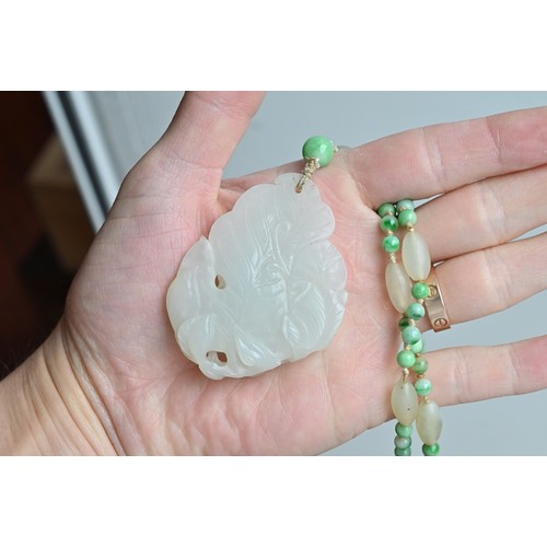 113 - A JADE JADEITE BEADED NECKLACE WITH PENDANTS, 19/20TH CENTURY. Comprising a carved and pierced jadei... 