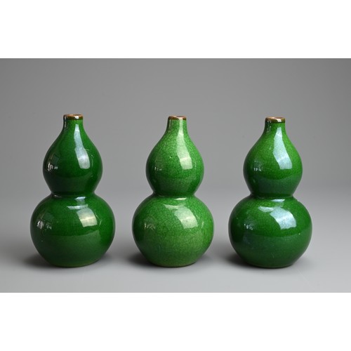 1 - THREE CHINESE GREEN CRACKLE GLAZED PORCELAIN VASES, LATE QING / REPUBLIC PERIOD. Each of double gour... 