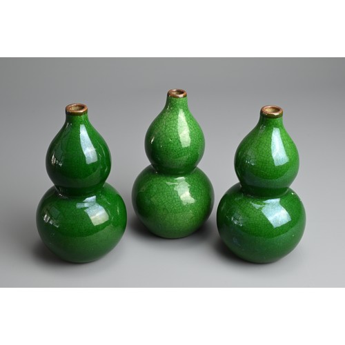 1 - THREE CHINESE GREEN CRACKLE GLAZED PORCELAIN VASES, LATE QING / REPUBLIC PERIOD. Each of double gour... 