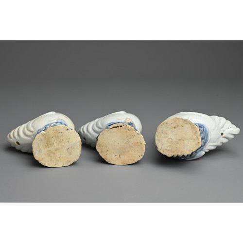 6 - THREE CHINESE BLUE AND WHITE PORCELAIN MODELS OF ROOSTERS, QING DYNASTY. Each standing on a rockwork... 