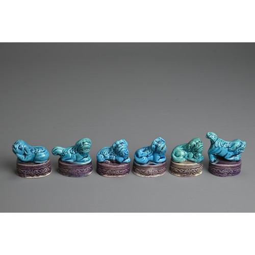 11 - A SET OF CHINESE TURQUOISE AND AUBERGINE GLAZED MODELS OF LION DOGS, EARLY 20TH CENTURY. Each in a d... 