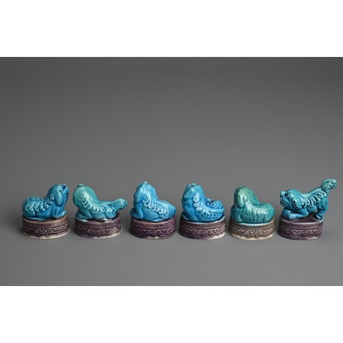 11 - A SET OF CHINESE TURQUOISE AND AUBERGINE GLAZED MODELS OF LION DOGS, EARLY 20TH CENTURY. Each in a d... 