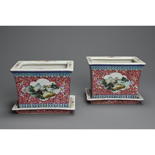 28 - A PAIR OF CHINESE RUBY GROUND AND FAMILLE ROSE DECORATED PORCELAIN JARDINIERES ON STANDS, 20TH CENTU... 