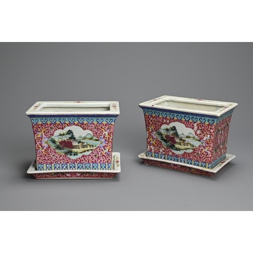 28 - A PAIR OF CHINESE RUBY GROUND AND FAMILLE ROSE DECORATED PORCELAIN JARDINIERES ON STANDS, 20TH CENTU... 