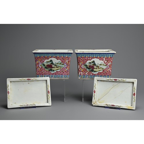 28 - A PAIR OF CHINESE RUBY GROUND AND FAMILLE ROSE DECORATED PORCELAIN JARDINIERES ON STANDS, 20TH CENTU... 