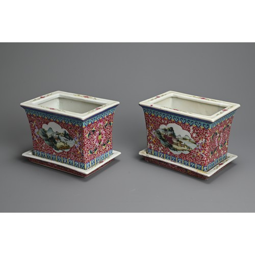 28 - A PAIR OF CHINESE RUBY GROUND AND FAMILLE ROSE DECORATED PORCELAIN JARDINIERES ON STANDS, 20TH CENTU... 