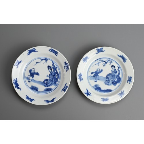 61 - A GROUP OF FOUR CHINESE BLUE AND WHITE PORCELAIN SAUCERS, EARLY 18TH CENTURY. To include a pair depi... 