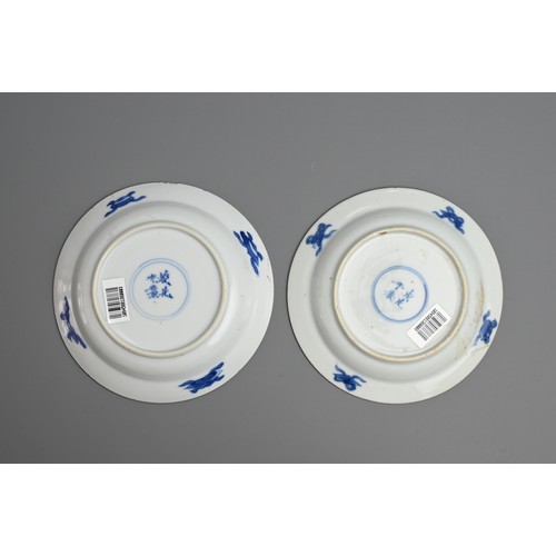 61 - A GROUP OF FOUR CHINESE BLUE AND WHITE PORCELAIN SAUCERS, EARLY 18TH CENTURY. To include a pair depi... 