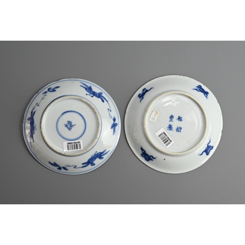 61 - A GROUP OF FOUR CHINESE BLUE AND WHITE PORCELAIN SAUCERS, EARLY 18TH CENTURY. To include a pair depi... 