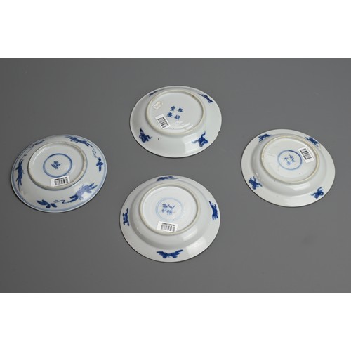 61 - A GROUP OF FOUR CHINESE BLUE AND WHITE PORCELAIN SAUCERS, EARLY 18TH CENTURY. To include a pair depi... 