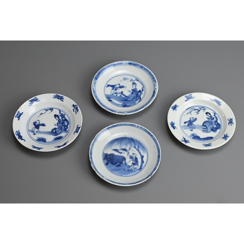 61 - A GROUP OF FOUR CHINESE BLUE AND WHITE PORCELAIN SAUCERS, EARLY 18TH CENTURY. To include a pair depi... 