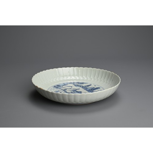 95 - A CHINESE BLUE AND WHITE PORCELAIN DISH, 18TH CENTURY. Finely potted with moulded lappet sides decor... 