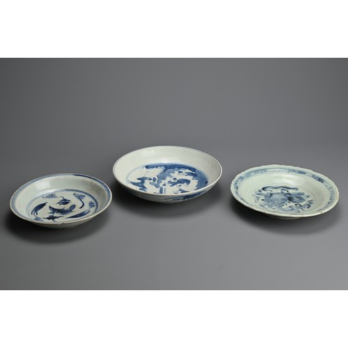 96 - THREE CHINESE BLUE AND WHITE PORCELAIN DISHES, LATE MING DYNASTY. A rounded dish decorated with scho... 