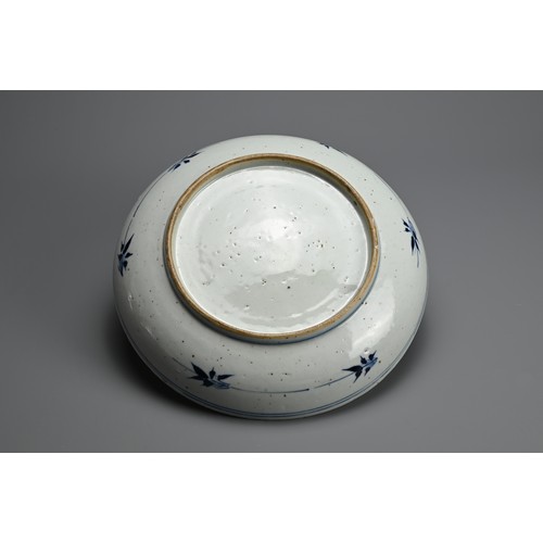 101 - A CHINESE BLUE AND WHITE PORCELAIN DISH, QING DYNASTY. Thickly potted with rounded sides decorated w... 