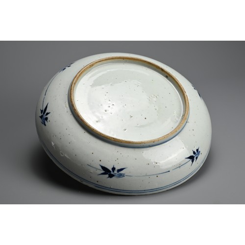 101 - A CHINESE BLUE AND WHITE PORCELAIN DISH, QING DYNASTY. Thickly potted with rounded sides decorated w... 