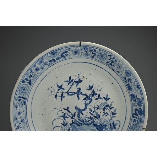 102 - A LARGE CHINESE BLUE AND WHITE PORCELAIN CHARGER, 19TH CENTURY. Finely decorated with birds perched ... 