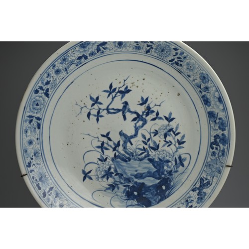 102 - A LARGE CHINESE BLUE AND WHITE PORCELAIN CHARGER, 19TH CENTURY. Finely decorated with birds perched ... 