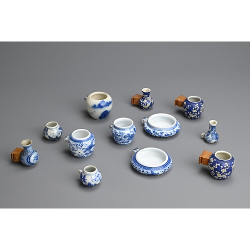 135 - A GROUP OF CHINESE PORCELAIN BIRD FEEDERS, 20TH CENTURY. Twelve of various forms with floral decorat... 