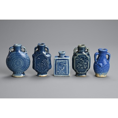 137 - A GROUP OF CHINESE BLUE GLAZED PORCELAIN BOTTLES, QING DYNASTY. Five medicine or snuff bottles of va... 