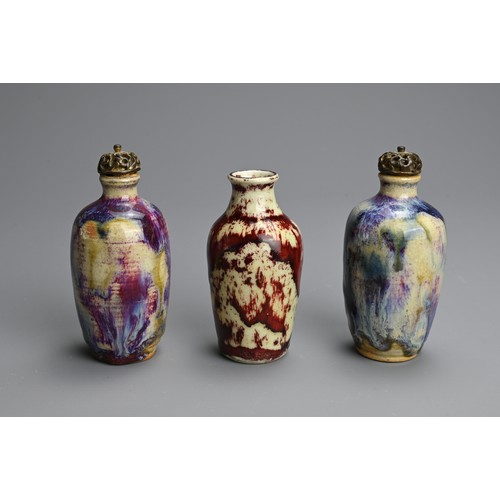 138 - THREE CHINESE FLAMBE GLAZED MINIATURE PORCELAIN BOTTLES, 19/20TH CENTURY. To include a pair of ovoid... 