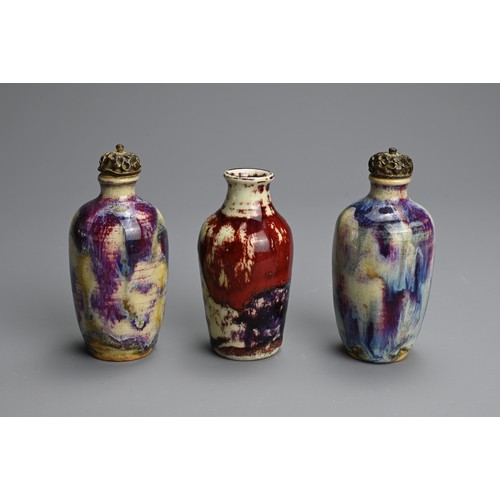 138 - THREE CHINESE FLAMBE GLAZED MINIATURE PORCELAIN BOTTLES, 19/20TH CENTURY. To include a pair of ovoid... 