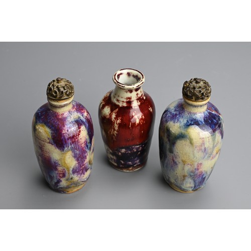 138 - THREE CHINESE FLAMBE GLAZED MINIATURE PORCELAIN BOTTLES, 19/20TH CENTURY. To include a pair of ovoid... 