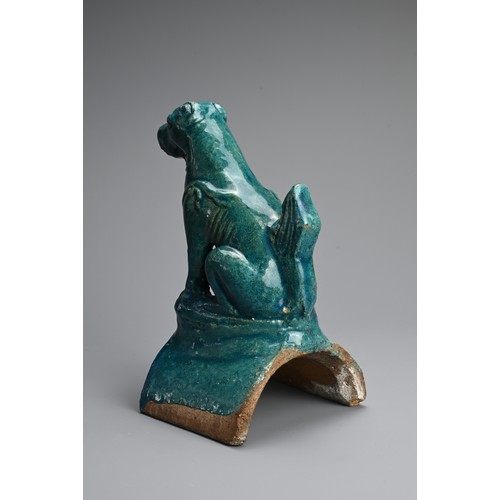 153 - A CHINESE TURQUOISE GLAZED POTTERY ROOF TILE, MING DYNASTY. In the form of a seated dog. 22cm tall. ... 