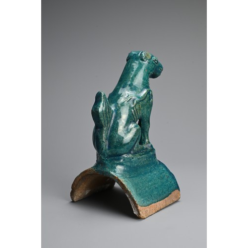 153 - A CHINESE TURQUOISE GLAZED POTTERY ROOF TILE, MING DYNASTY. In the form of a seated dog. 22cm tall. ... 