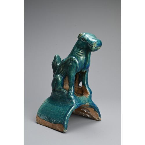 153 - A CHINESE TURQUOISE GLAZED POTTERY ROOF TILE, MING DYNASTY. In the form of a seated dog. 22cm tall. ... 