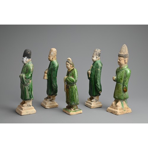 155 - A GROUP OF CHINESE SANCAI GLAZED POTTERY FIGURES OF ATTENDANTS, MING DYNASTY. Four male and one fema... 