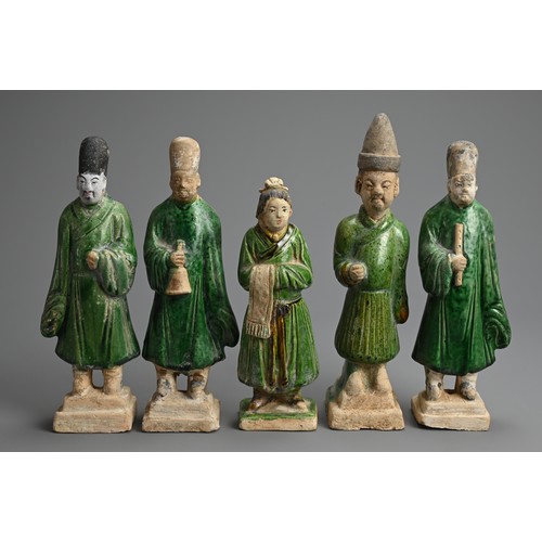 155 - A GROUP OF CHINESE SANCAI GLAZED POTTERY FIGURES OF ATTENDANTS, MING DYNASTY. Four male and one fema... 