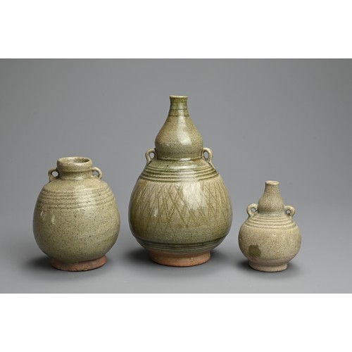 199 - THREE THAI SAWANKHALOK CELADON GLAZED STONEWARE VASES, CIRCA 15TH CENTURY. Two double gourd form vas... 