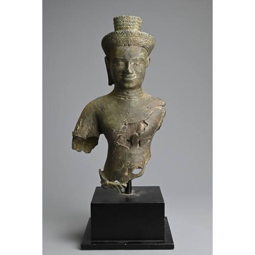 259 - A CAMBODIAN BRONZE TORSO OF A DEITY, PROBABLY ANGKOR PERIOD 9TH - 14TH CENTURY. The male deity weari... 