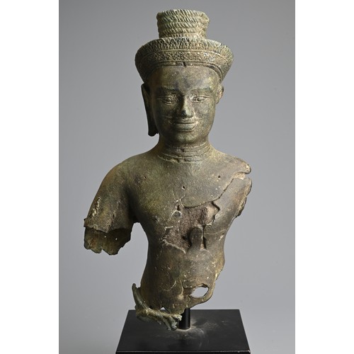 259 - A CAMBODIAN BRONZE TORSO OF A DEITY, PROBABLY ANGKOR PERIOD 9TH - 14TH CENTURY. The male deity weari... 