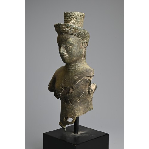 259 - A CAMBODIAN BRONZE TORSO OF A DEITY, PROBABLY ANGKOR PERIOD 9TH - 14TH CENTURY. The male deity weari... 