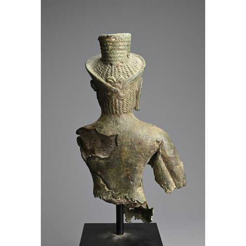 259 - A CAMBODIAN BRONZE TORSO OF A DEITY, PROBABLY ANGKOR PERIOD 9TH - 14TH CENTURY. The male deity weari... 