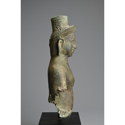 259 - A CAMBODIAN BRONZE TORSO OF A DEITY, PROBABLY ANGKOR PERIOD 9TH - 14TH CENTURY. The male deity weari... 