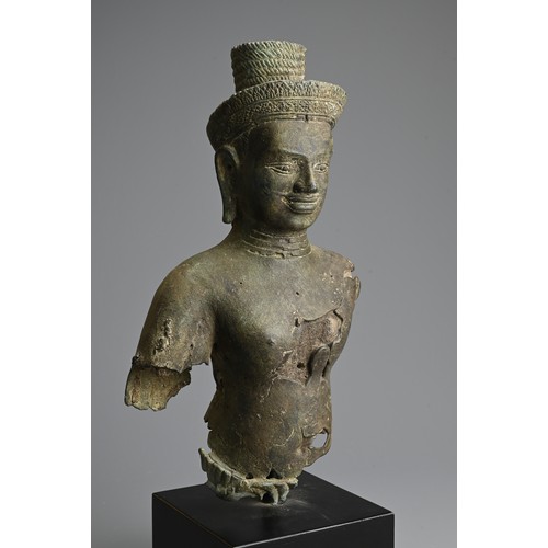 259 - A CAMBODIAN BRONZE TORSO OF A DEITY, PROBABLY ANGKOR PERIOD 9TH - 14TH CENTURY. The male deity weari... 